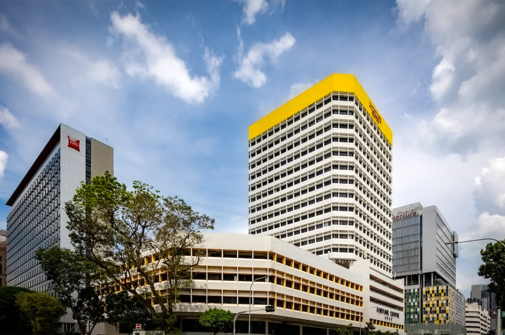 Fortune Centre building on Bencoolen Street in Singapore with surrounding hotels and city skyline under a bright sky