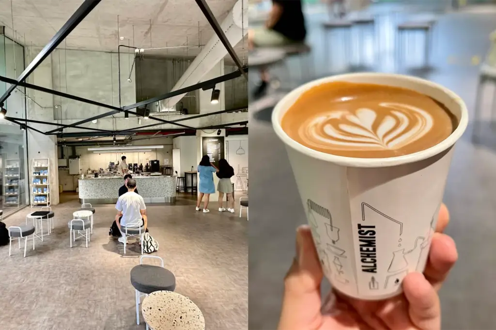 A split image showcases the industrial, minimalist interior of an Alchemist café on the left, complete with concrete walls, high ceilings, and small round seating arrangements. On the right, a hand holds a takeaway paper cup branded with the Alchemist logo, filled with a hot latte topped with detailed tulip latte art.